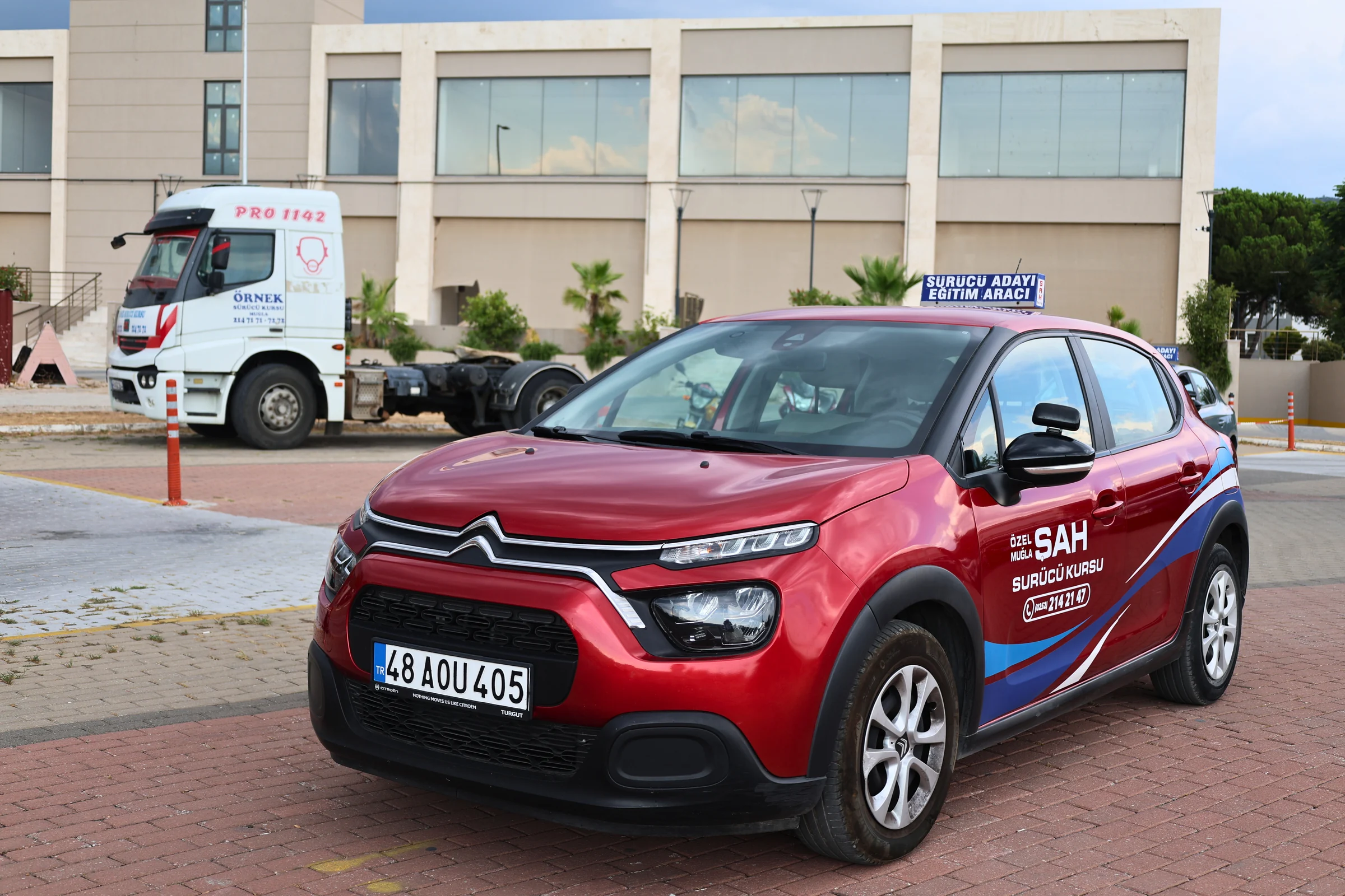 A red Citroen driver-training car from Şah Driving School