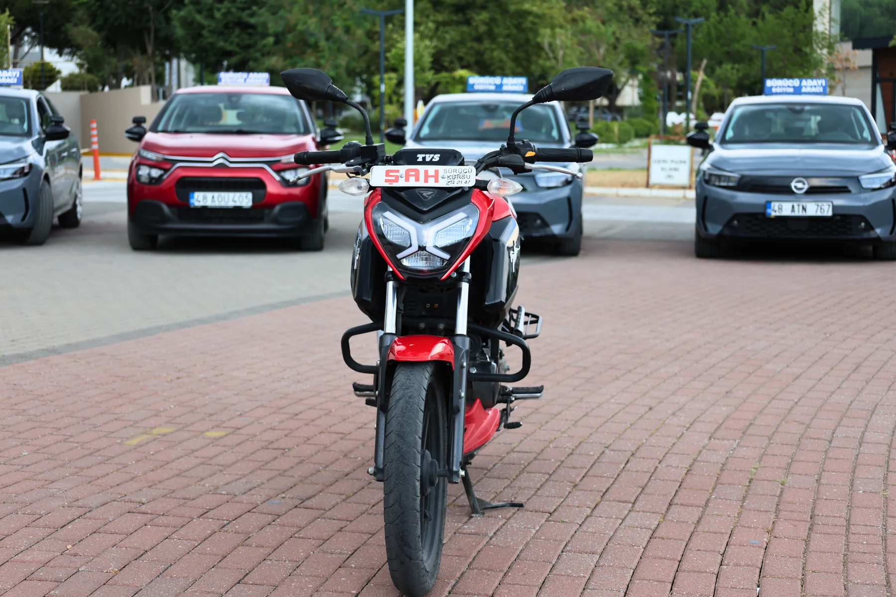 Front view of a TVS motorcycle used for training at Şah Driving School