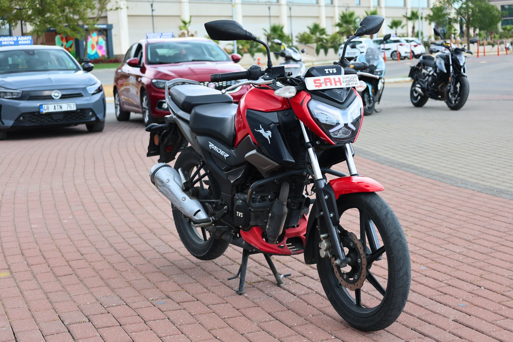 Side view of a TVS motorcycle used for training at Şah Driving School